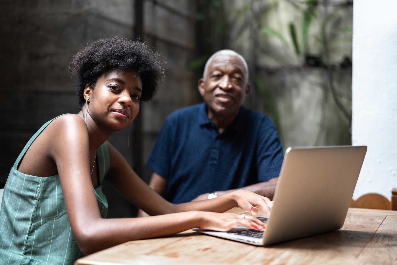 Man playing with grandson at desk