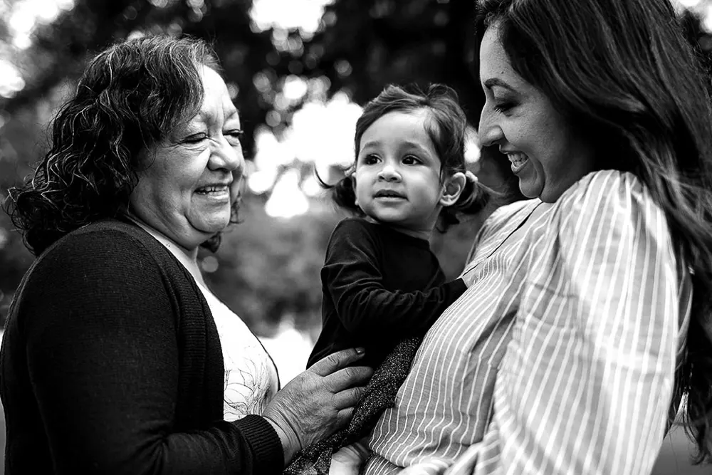 A grandmother enjoys time with her daughter and grandchild as they help the child understand more about Alzheimer's disease