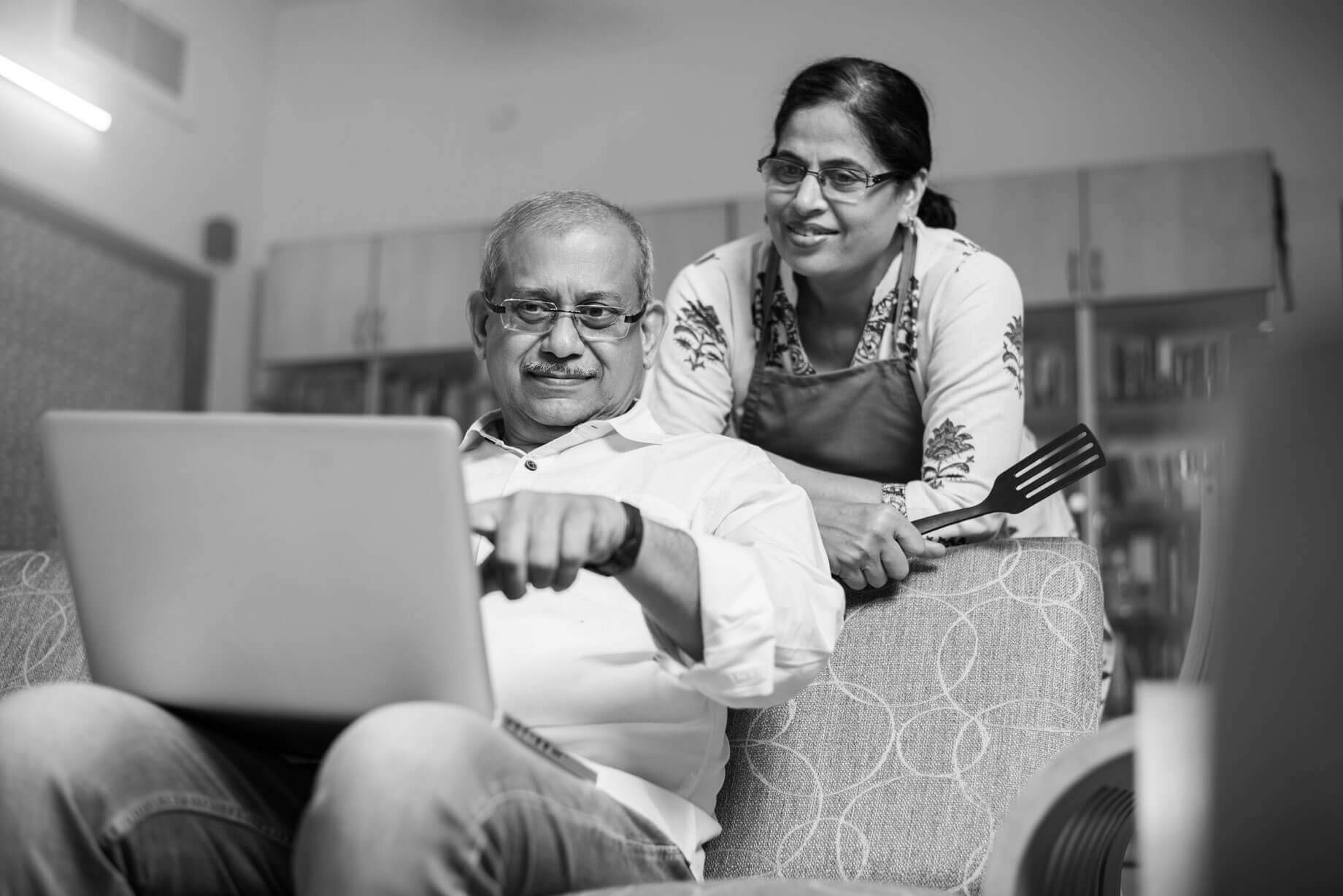 Man helping grand daughter draw