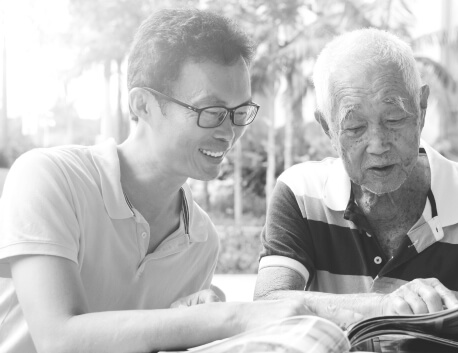 Man reading from magazine with son