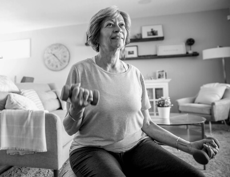 Woman lifting weights in living room