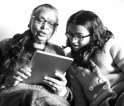 Woman reading from tablet with daughter