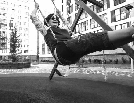 Woman laughing while swinging on swing